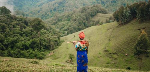 Woman standing on agricultural land.