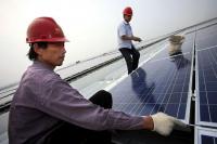 Workers install solar photovoltaic panels on roofs. (Shanghai, China)