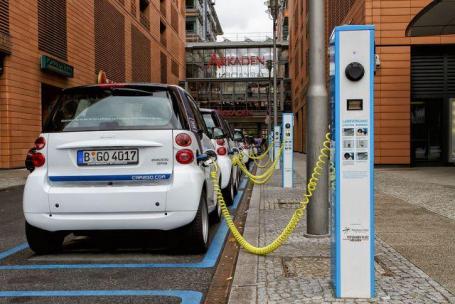 Small cars plugged into charging stations