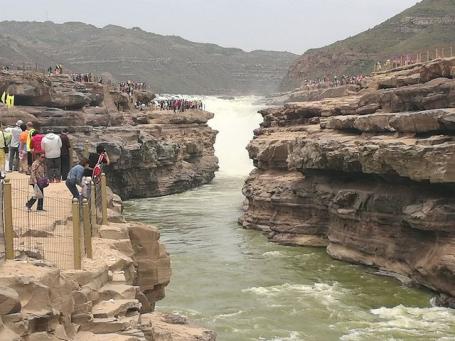 People standing on rocks at Yellow River