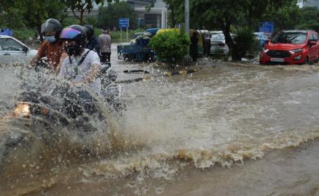 Motorcycle on flooded street. Sudarshan Jha/Shutterstock