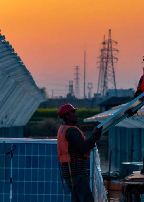 men installing solar panels in China